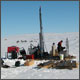 Core drilling on a frozen lake in the far  North